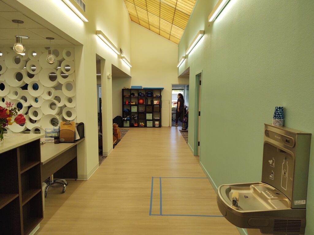 Central corridor towards open gym area and therapy rooms